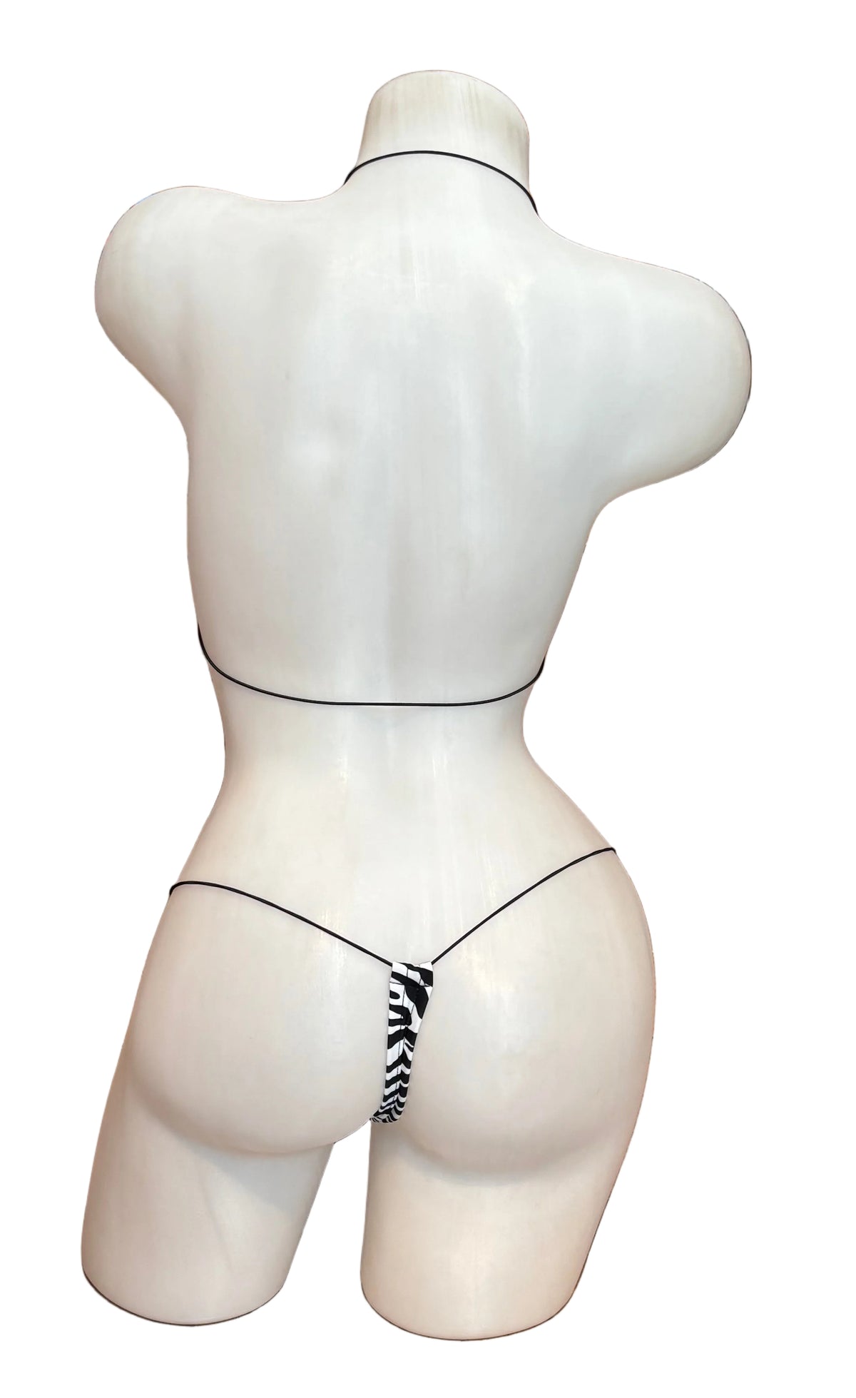 BL Micro Nudie Zebra Bikini showing a slim, zebra-print bikini with thin straps and minimal coverage on a model.