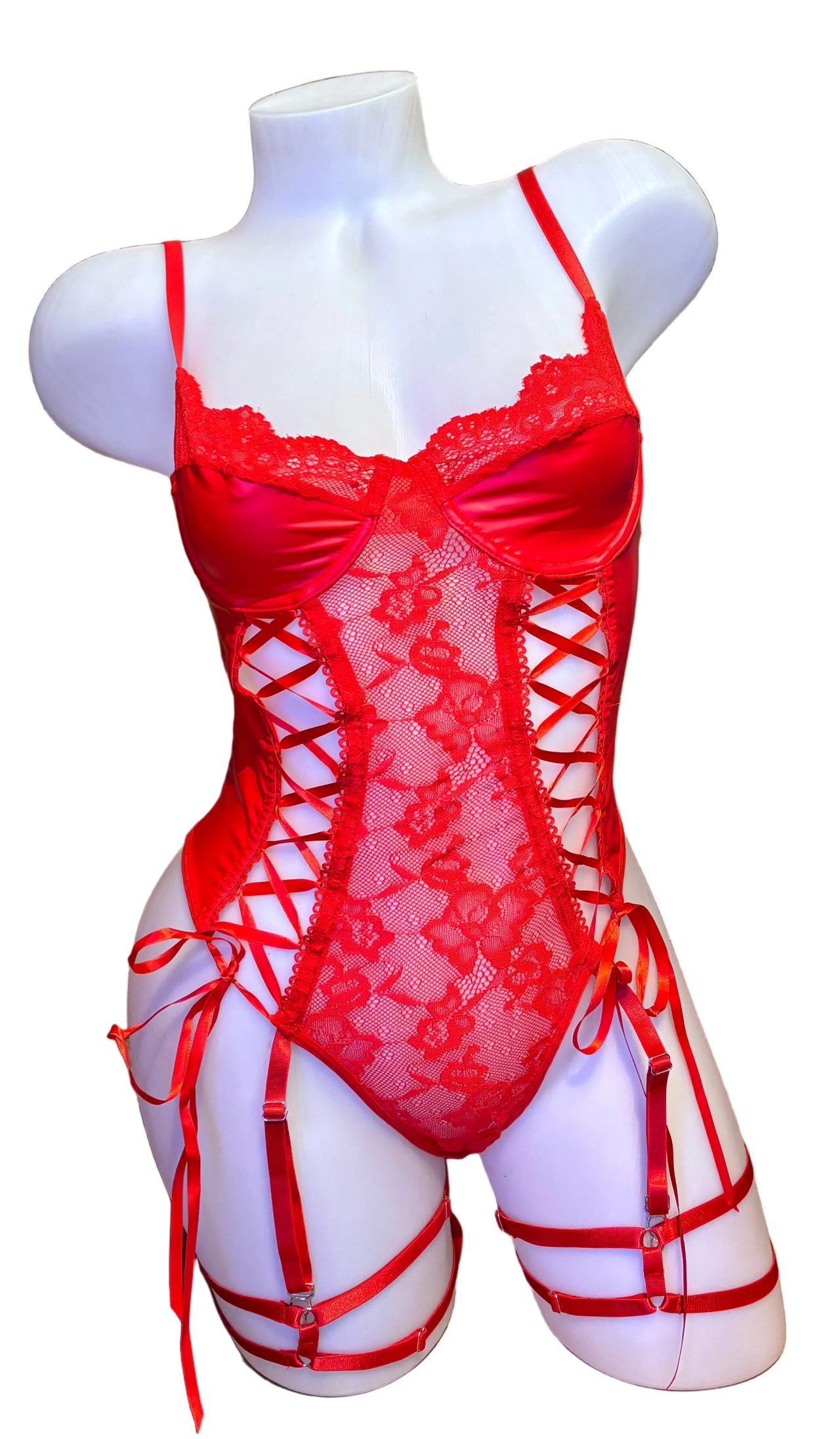 Red bondage bodysuit lingerie by BS with matte finish, lace accents, and strappy detail, shown on a model.